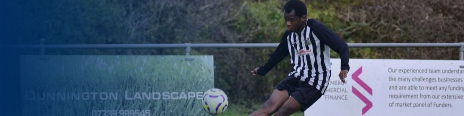 FOOTBALL - image shows player about to kick ball, there is advertising boards in the background